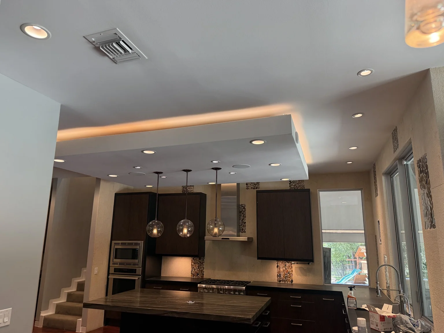 Kitchen with recessed and pendant lighting