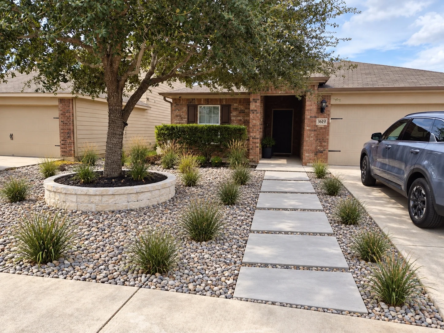 Front yard landscaping with stone and walkway